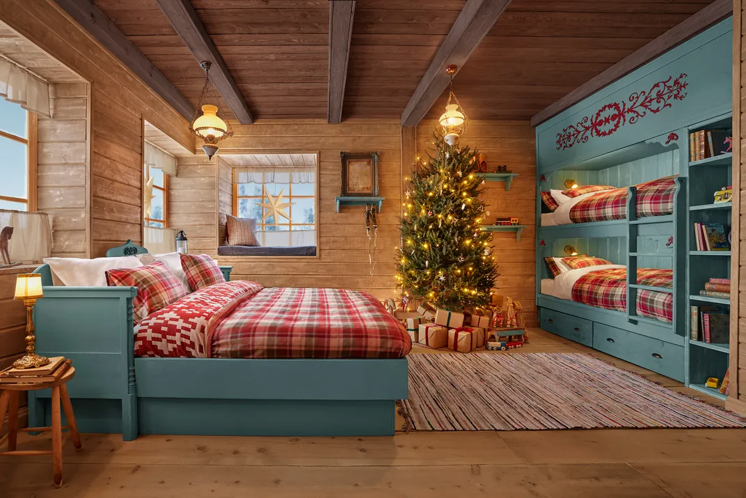 Full bed with bunk beds in holiday-themed cabin
