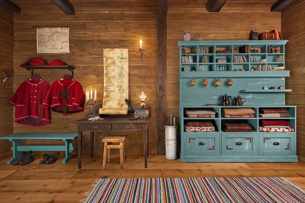 Interior cabin wall with furniture and red clothing