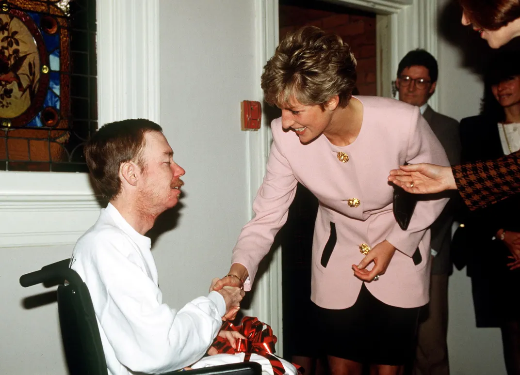Diana shakes hands with an AIDS patient in 1991.