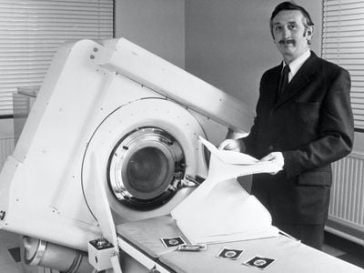 Godfrey Hounsfield stands beside the EMI-Scanner in 1972.