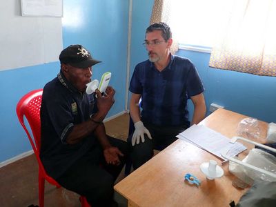 Working with the Papuan Past Project, François-Xavier Ricaut measures the lung function of a highlander study participant at St. Therese’s School at Denglagu mission.