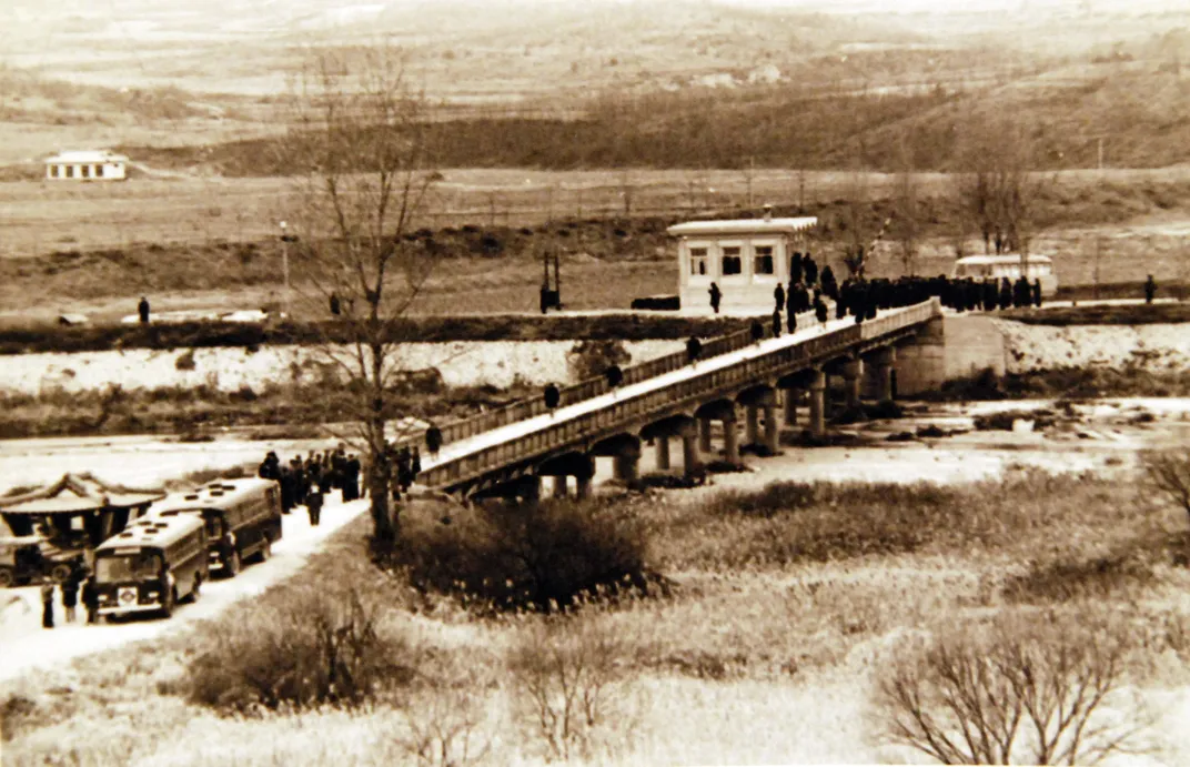 The crew of the USS Pueblo walks into the DMZ following the men's release by North Korea in December 1968.