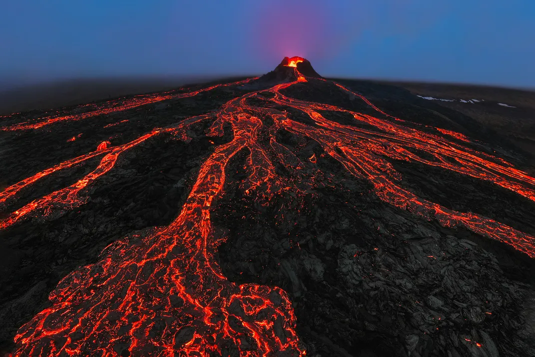 11 - A drone captures the eerie eruption of a volcano in Iceland as fiery lava escapes and pours onto the earth.