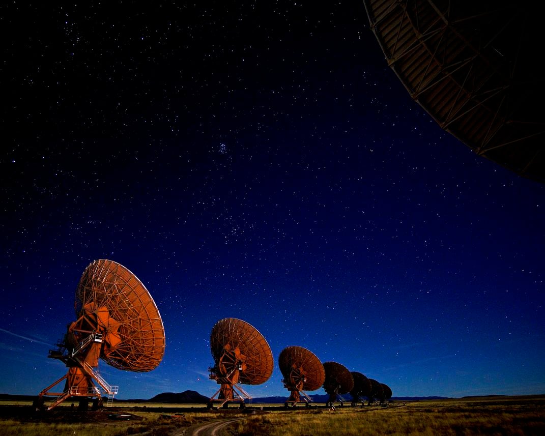 Large radio telescopes dot the horizon