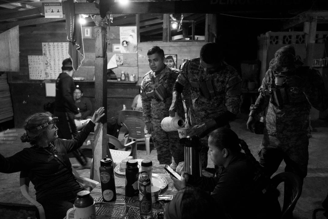 Veelenturf meets with Genoveva “Nelly” Forero (seated at table, bottom right), a naval captain who provides security to the project and also helps with its research.