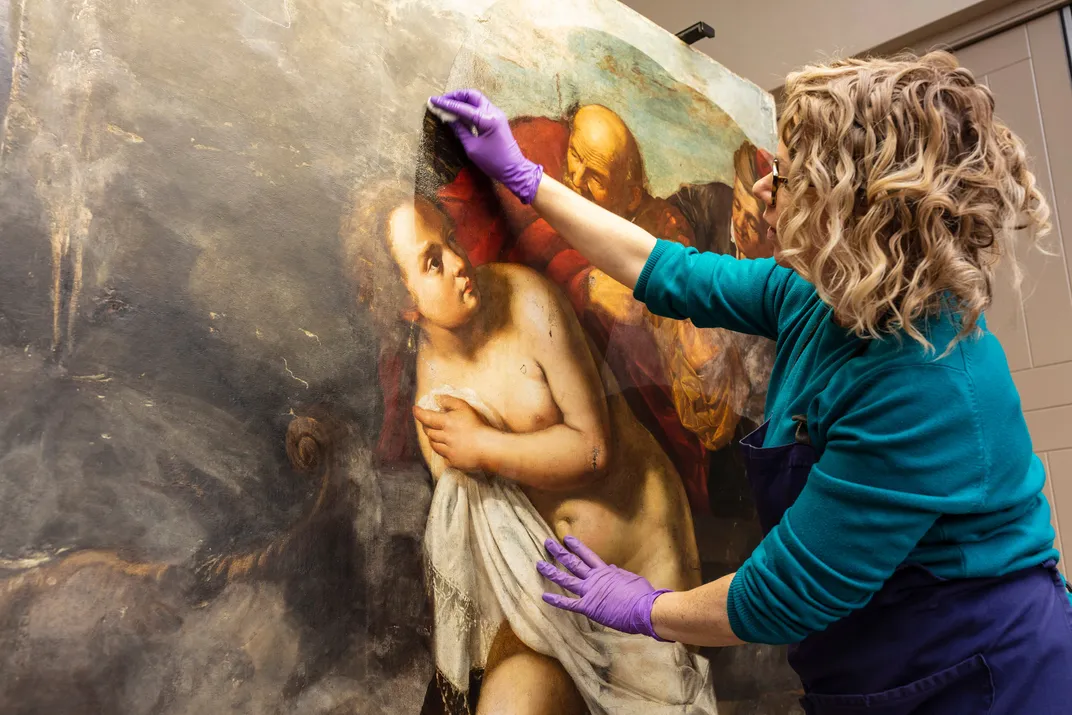 Conservator Adelaide Izat works on Susanna and the Elders​​​​​​​, a painting newly reattributed to Artemisia Gentileschi.