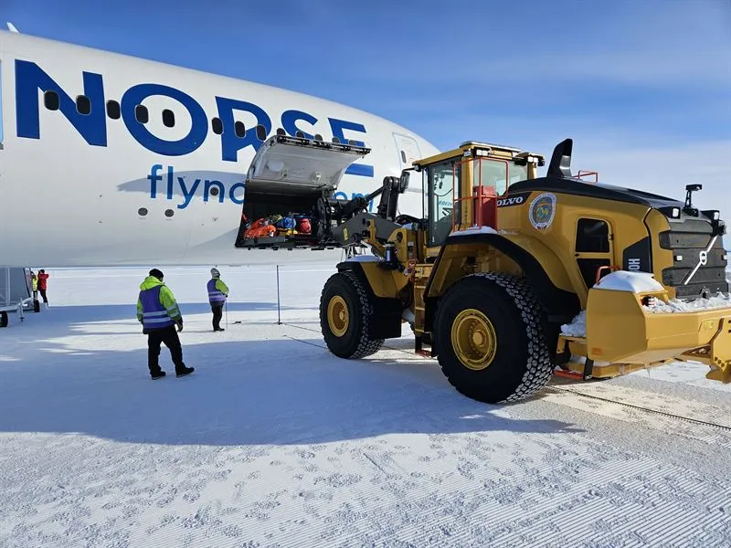 Construction vehicle unloaded supplies from large plane