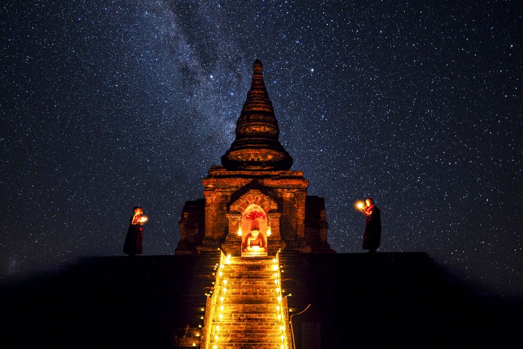 A nighttime ceremony is performed under a heavenly, star-filled sky.