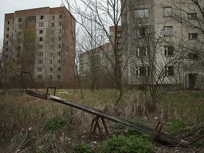 A children's seesaw stands among former apartment buildings in Pripyat, Ukraine. Pripyat, built in the 1970s to house the workers and families of the Chernobyl Nuclear Power Plant, now stands abandoned inside the Chernobyl Exclusion Zone.