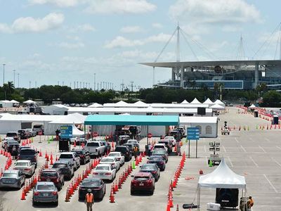 Cars line up at a drive-in coronavirus testing site in Miami Gardens, Florida, in late June. Testing in many states has been hampered by bottlenecks and long delays, problems that could be eased by the rapid, simple tests scientists are now developing.