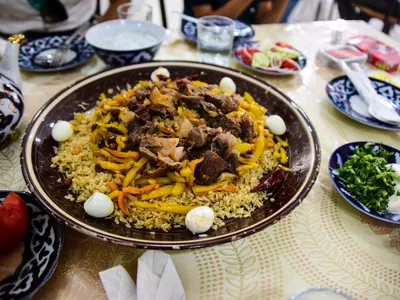 Plov is a dish made of rice, beef or lamb, oil or animal fat, carrots (usually cut into matchsticks), and onions, cooked with cumin and salt in a large pot.