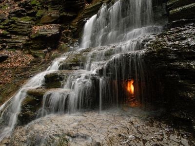 This small, bucolic waterfall in Western New York has one highly photogenic feature: a grotto lit by a dancing orange flame.