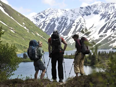 Backpackers hike near Crescent Lake in Alaska&#39;s Chugach National Forest.