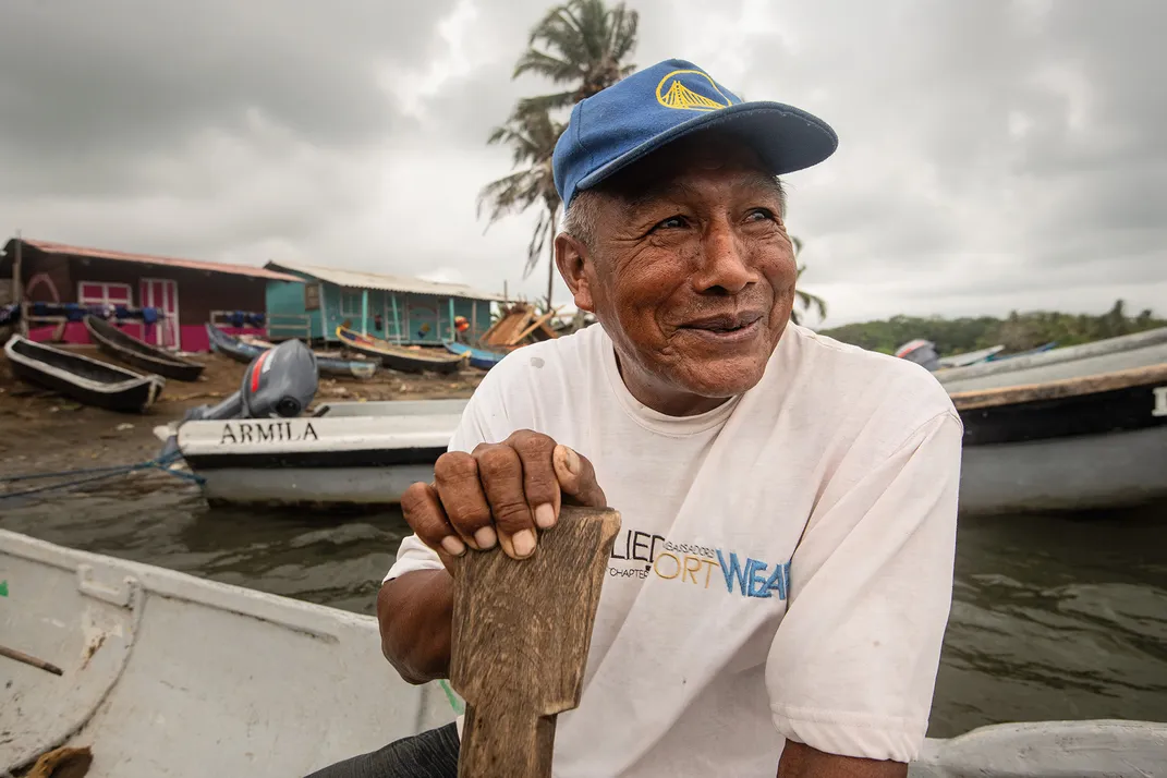 Aderano Martinez Torres, a chief in the Guna village. The watercraft in the village range from speedboats to dugout canoes made from hollowed logs.