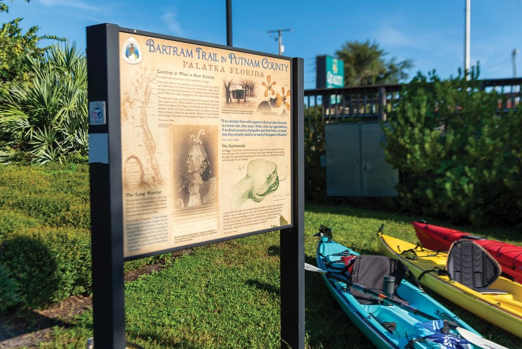 kayaks sit next to an trail map showing key site along a historic trail