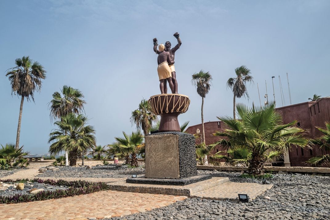 On Gorée Island off the coast of Senegal, a statue of freed slaves stands not far from a former fort where captured Africans last saw their homeland.