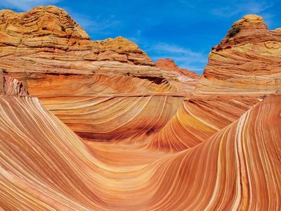 A stunning landscape featuring a wavy sandstone rock formation