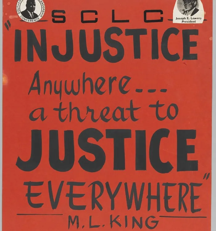 A black ink on a red-orange poster board with a small picture of Martin Luther King, Jr. at the top left and Joseph Lowery at the top right. The poster reads: [SCLC / INJUSTICE / Anywhere... / a threat to / JUSTICE / EVERYWHERE / M. L. KING].