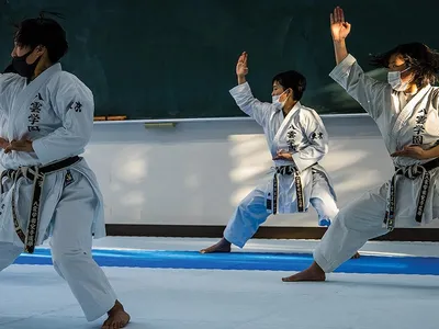 Yakumo Academy High School karate team members practice a kata. Competitors are judged on such things as strength/power, deportment and interpretation.