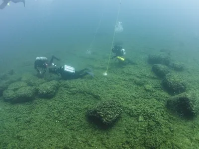 Archaeologists collect samples from a prehistoric caribou hunting site on Alpena-Amberley Ridge in Lake Huron.