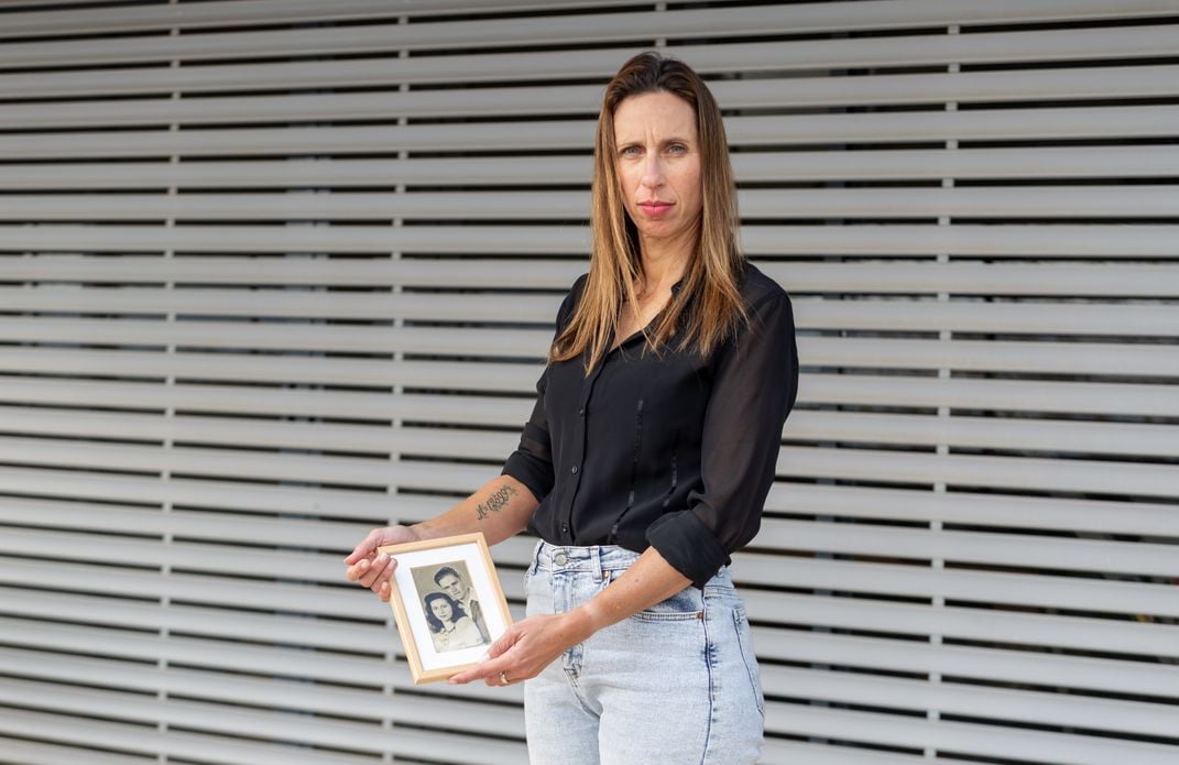 Orly Weintraub Gilad holds a photograph of her maternal grandparents.