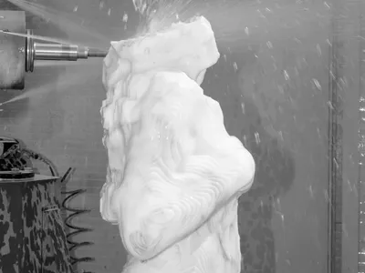 Pressurized water shoots from the drill&rsquo;s head to cool the marble and prevent excessive dust (detail).