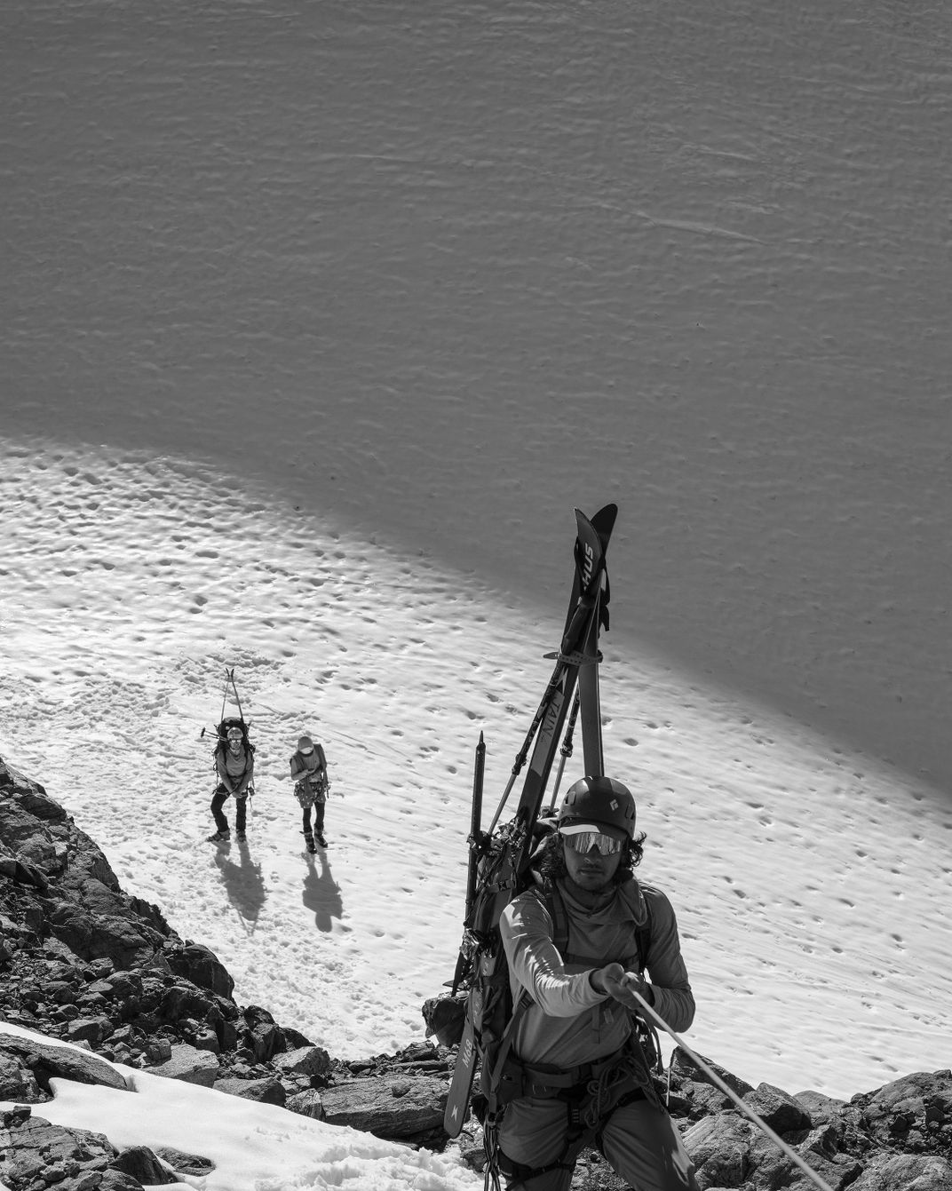 Vijay Jain climbs toward Nugget Ridge as his party leaves the Lemon Glacier. Junior staff member Jon Kaufmann checks their position via GPS.
